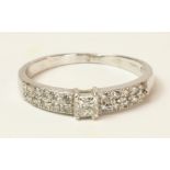 Hallmarked 18ct white gold ring set with princess cut central diamond and twenty further diamonds