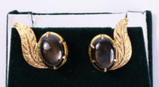 Pair leaf scroll ear-rings set with black star sapphires tested to 18ct Condition Report