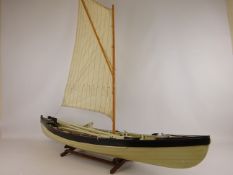 Scale model of a whaling boat, single mast and sail with oars, boathooks and harpoons,