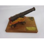 Apprentice made model of a brass canon on a wooden carriage,