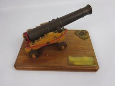 Apprentice made model of a brass canon on a wooden carriage,