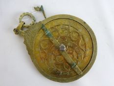 17th Century style Persian brass astrolabe, of typical form with engraved Arabic script, H25cm.