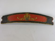 19th century painted ships curved sternboard, decorated with initials I LS in gilt scroll reserve,