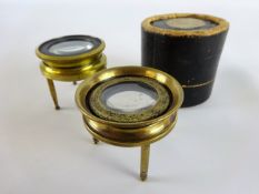 Late 19th century brass insect viewer, single lens on three turned legs in card case,