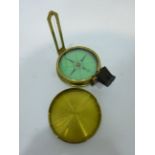 Late 19th century brass pocket compass and cover, green paper dial inscribed 'Elliott Bros Strand,