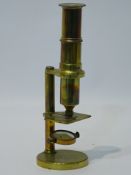 20th century brass compound microscope, with slide adjustment on circular base, H24cm.