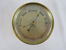 Late 19th century brass case Aneroid Barometer with silvered dial and suspension ring, D13.5cm.