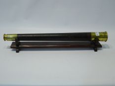 19th century brass & leather single draw telescope, with end cap, on wooden stand, L76cm max.