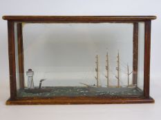Diorama of a four master, towed by a steam tug passing a lighthouse, in glazed case, W40cm, D16cm,