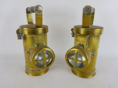 Two Ceag brass Inspection Lamps, cylindrical bodies with clear glass lens and turned wooden handles,