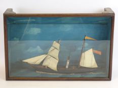 Cased niave diorama of the two masted sail-steamship 'Brigand', passing a lighthouse, W40cm, D11cm,