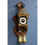 Dutch style wall hanging clock, with Atlas figure, striking the hours and halves on bell,