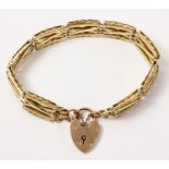 Gold crossed bar gate bracelet the heart padlock stamped 9ct approx 19gm Condition Report