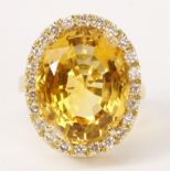 Large oval citrine and diamond cluster ring marked 18k, citrine approx 20 carat, diamonds 0.