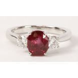 Oval ruby and round brilliant cut diamond three stone ring hallmarked 18ct,