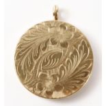 Gold circular locket pendant, bright cut floral decoration hallmarked 9ct approx 11.
