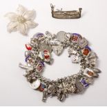 Hallmarked silver charm bracelet with threepenny pieces and various charms,
