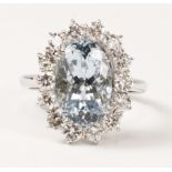 Oval aquamarine and diamond cluster ring hallmarked 18ct, aqua approx 3.