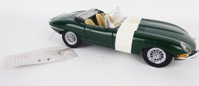 Franklin Mint 1;24 scale die-cast model of a 1961 open top E-Type Jaguar, green with wire wheels,