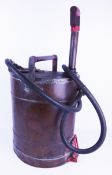 Vintage brass stirrup pump fire hose and water container,