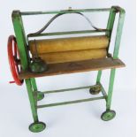 Tri-ang toy mangle, green painted metal frame with wooden rollers, with oil can,