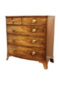 Early 19th century mahogany bow front chest fitted with two short and three long drawers,