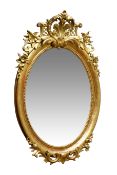 Late 19th century Chippendale style oval wall mirror pierced cresting with floral and scroll detail,