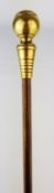 Swagger stick cane with brass tapering handle, the ball finial with Royal Crest,
