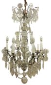 Gilt metal chandelier, with six branches around a central glass covered column,