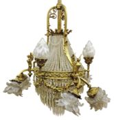 Cast brass nine light chandelier with central coronet and prismatic swags above three torch and