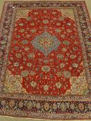 Persian Sarough red ground rug carpet, scrolling floral design, with blue medallion and border,