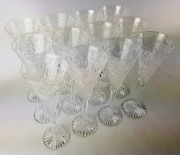 Set of twelve Stuart crystal champagne flutes with ribbon tie and hobnail cut decoration on faceted