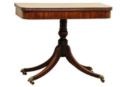 Regency mahogany folding tea table with reeded top on turned column and four sabre legs with brass