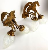 Pair of 20th century cast gilt metal two branch wall lights with winged mythical beast cresting,