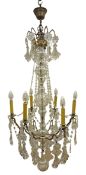Gilt metal chandelier, with six branches around a central glass covered column,