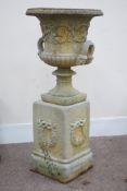 Large stone effect garden urn scrolling foliage decoration, on stepped plinth base,