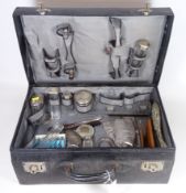 Early 20th Century leather vanity case with various hallmarked silver fittings,