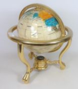 Polished mineral table Globe on brass stand with compass base,