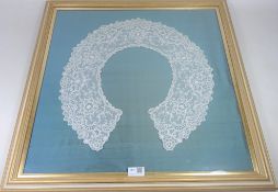 Framed Victorian lace collar with floral sprays, mounted on silk,