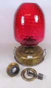 Early 20th Century oil lamp with cranberry glass shade. H.