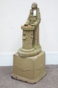 Composite stone garden figure of a praying monk, on plinth,