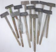 Thirteen 1930's cast metal plant labels,