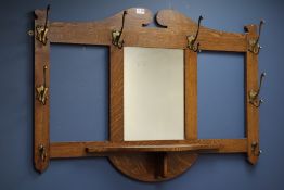 Early 20th century oak wall hanging hat and coat stand with centre mirror, W107cm,