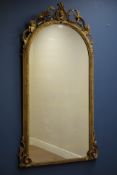 Victorian gilt wood and gesso arched top mirror, with scrolling foliage decoration,