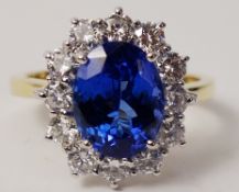 18ct oval tanzanite and round brilliant diamond cluster ring hallmarked 18ct (tanzanite approx 2.