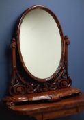 Victorian mahogany oval swing dressing table mirror, moulded serpentine base, with carved horns,
