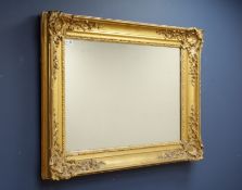 19th century wall mirror in swept gilt frame with applied gesso decorative moulding,