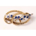 Sapphire and diamond set 9ct gold bark scroll brooch maker's mark LD Ltd London 1973 approx 7.