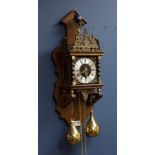 Dutch style wall hanging clock, with Atlas figure, striking the hours and halves on bell,