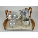 Four piece Piquot ware tea set on tray, with wooden handles,